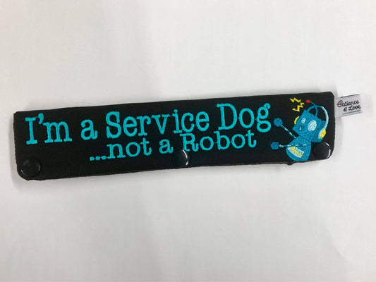  One Leash Sleeve embroidered on both sides of the sleeve with  I'm a Service Dog, Not Robot with a cute robot next to the text.  As seen in the listing photo.   Example listing photo has black fabric and 1799 text.