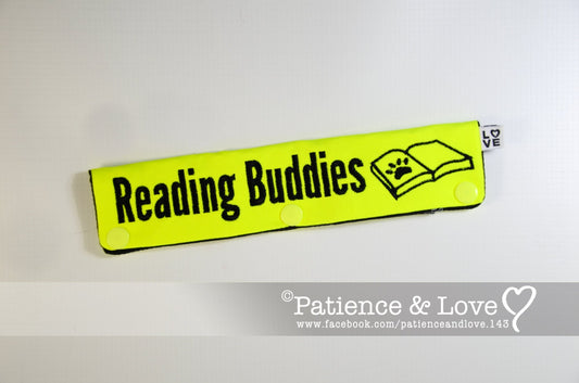 One Leash Sleeve embroidered with the following on both sides of the sleeve       Reading Buddies with an open book and a paw   As seen in the listing photo.   Listing photo shows bright yellow fabric with black text.