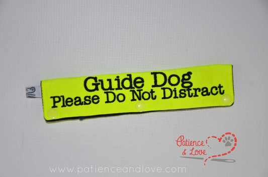 Bright yellow leash sleeve with black text that reads "Guide Dog Please Do Not Distract"