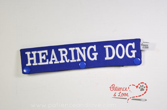 One Leash Sleeve embroidered with the following on both sides of the sleeve:      HEARING DOG     Example in the listing photo has the following color selections:        • Blue fabric, White (1805) text.