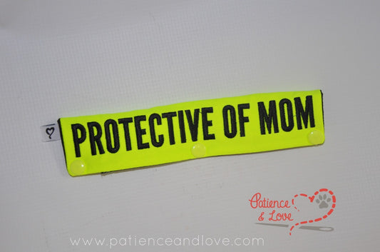 One Leash Sleeve embroidered with the following on both sides of the sleeve:       PROTECTIVE OF MOM     Example in the listing photo has the following color selections:        • Bright yellow fabric, Black (1800) text.